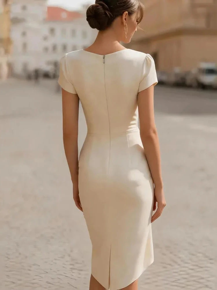 Rosalinda, abito midi beige visto di schiena