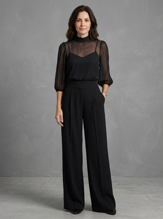 Dalia — completo nero con blusa trasparente e pantalone a gamba larga, vista frontale